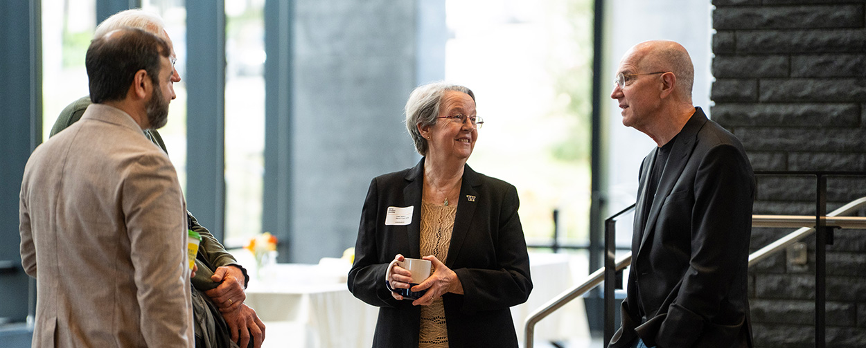 Lianne Sheppard, symposium organizer and Rohm & Haas endowed professor in public health sciences at the UW, and Christopher Portier, adjunct professor at Emory University, talk with participants on the UW campus during the Seattle Glyphosate Symposium.