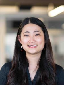 Headshot of Esther, a young Asian woman with long hair