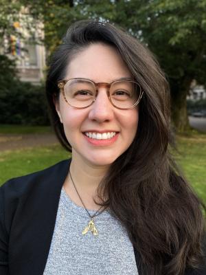 Marie Spiker, a young woman with large tortoiseshell glasses and long dark brown hair