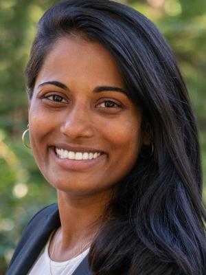 Person with long black hair swept to the side