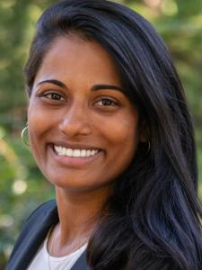 Person with long black hair swept to the side