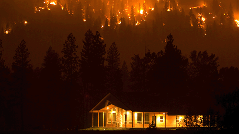 House with wildfire in background