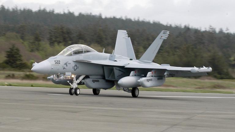 A US Navy Growler aircraft lands on a runway on Whidbey Island.