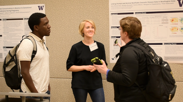 Kate McConnell talks with people about her research project at Graduate Student Research Day