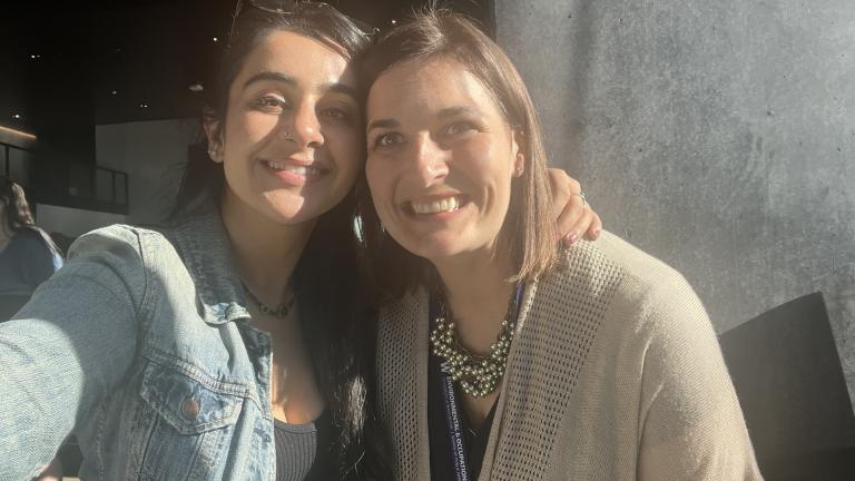 Amber Khan and Nicole Errett stand together smiling.