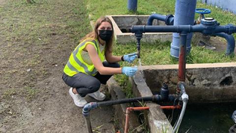 Student taking water sample