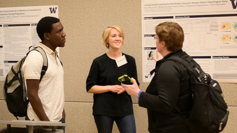 Kate McConnell talks with people about her research project at Graduate Student Research Day