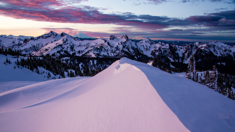 Purple and blue sunset over snowy mountains