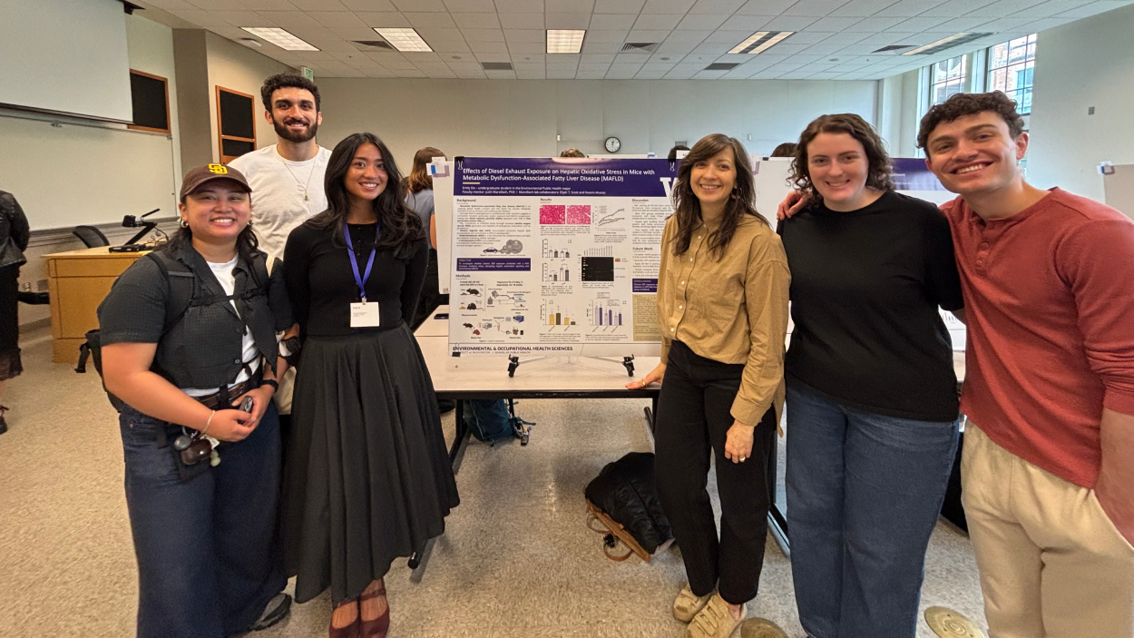 Six people including Emily Do stand around a research poster.