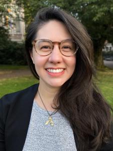 Marie Spiker, a young woman with large tortoiseshell glasses and long dark brown hair